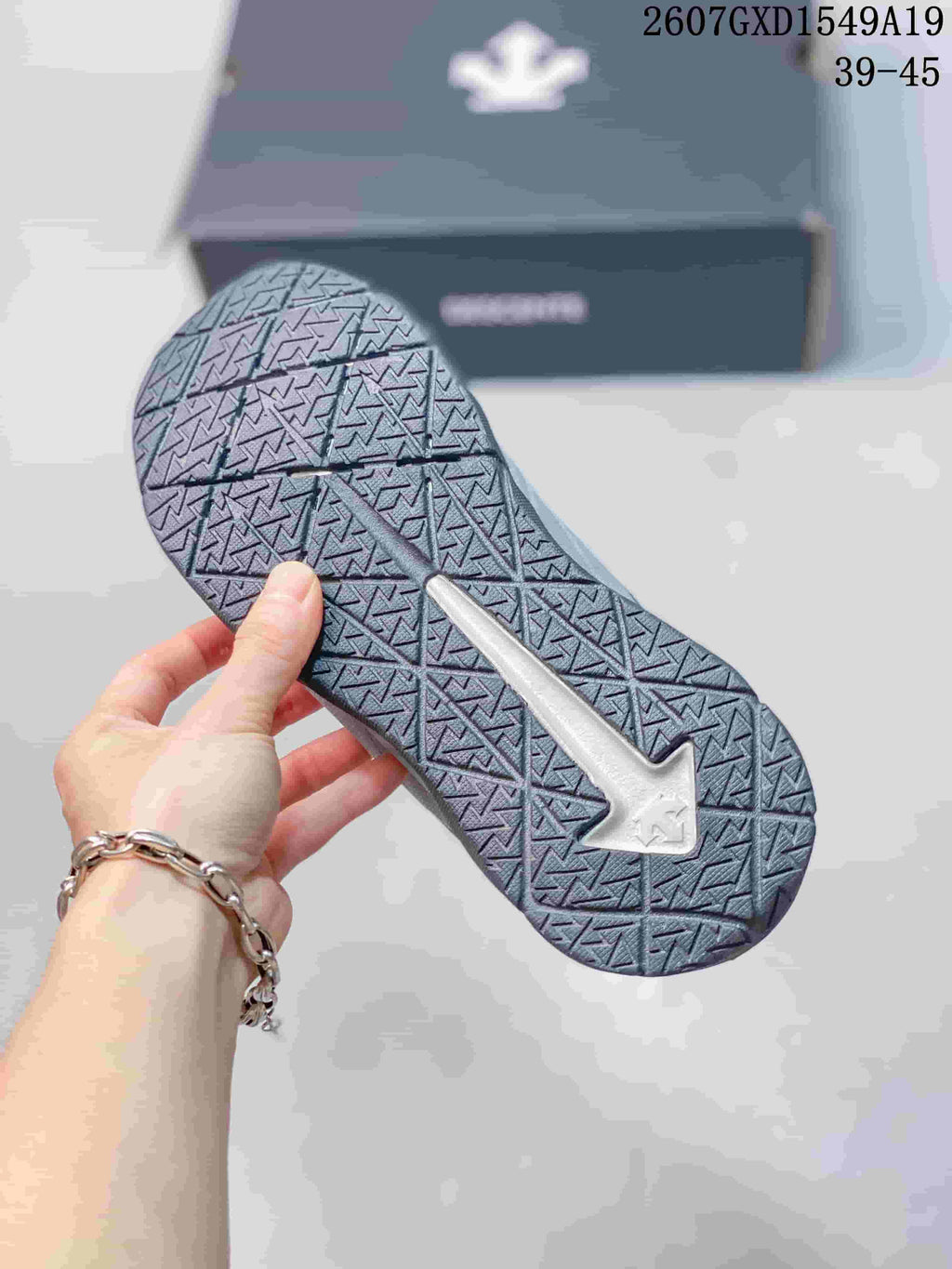 Close-up of the patterned rubber outsole with a repeating geometric tread design.