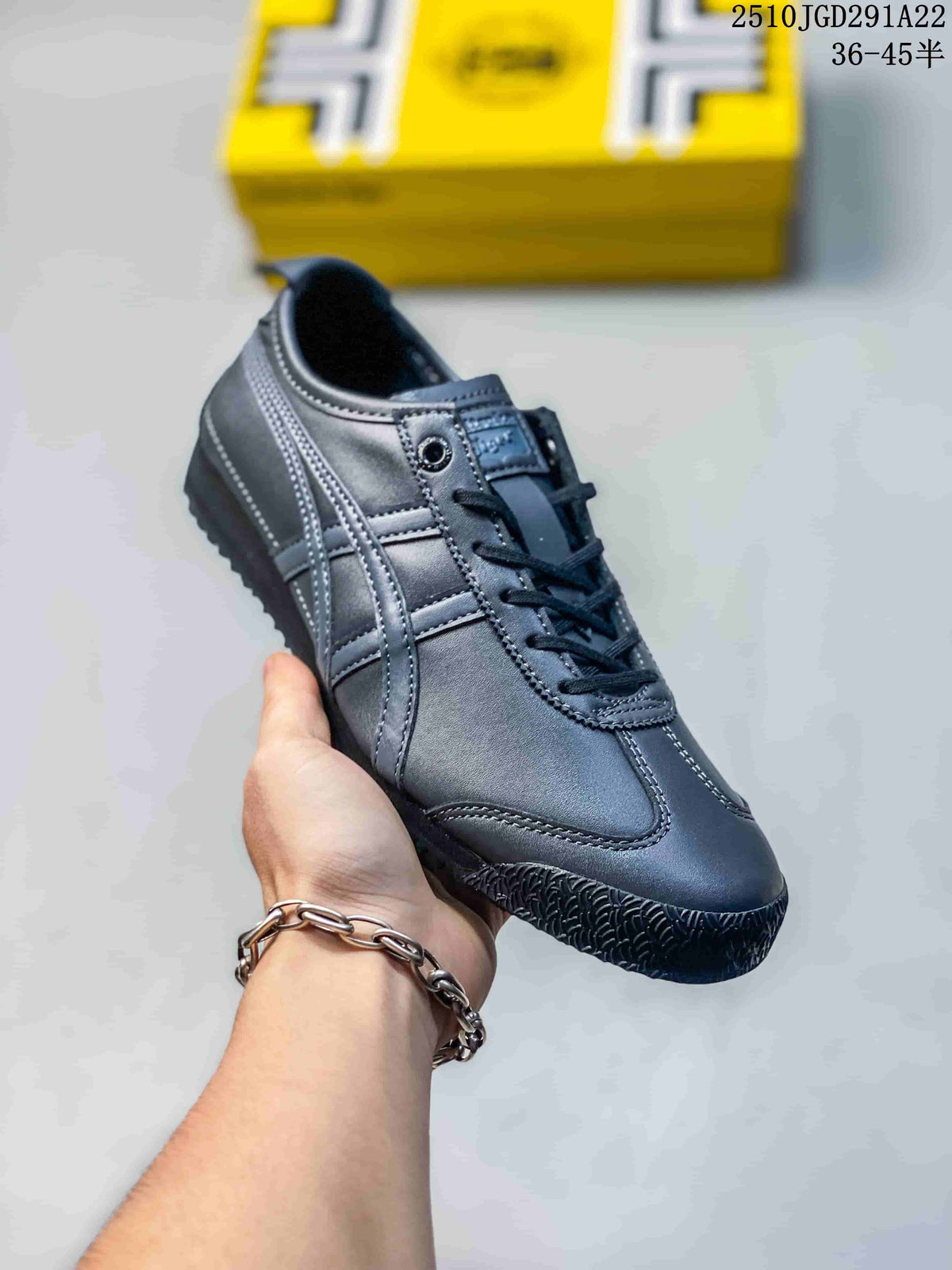 Angled side view of the black sneaker showing the lace-up upper, layered stripes, rounded toe, and textured outsole.