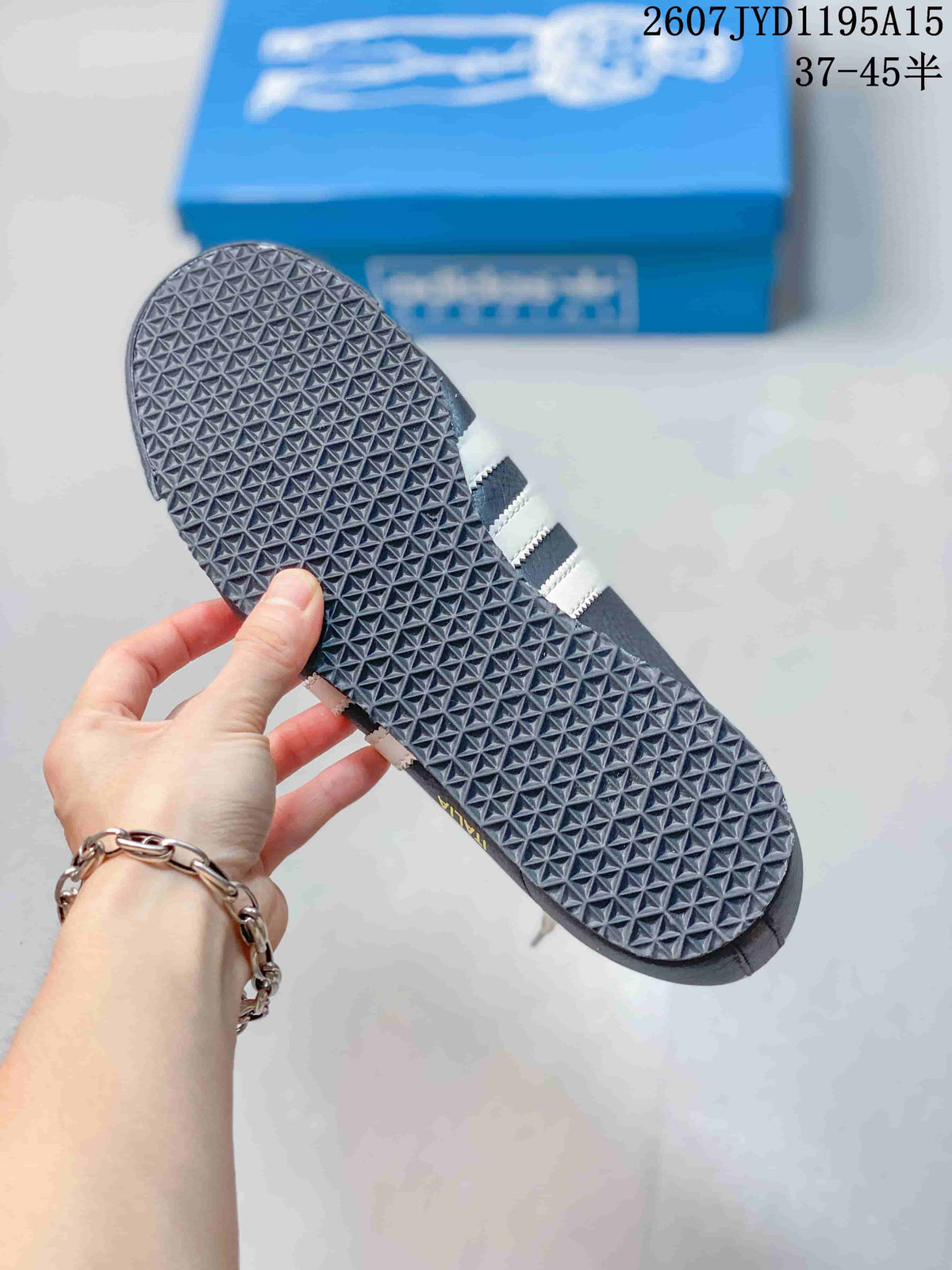 Close view of the sneaker outsole showing a dense geometric traction pattern.