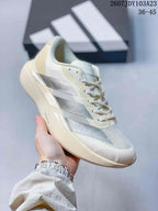 Angled side view of the off-white sneaker showing the silver side stripes, lace eyelets and sculpted sole.