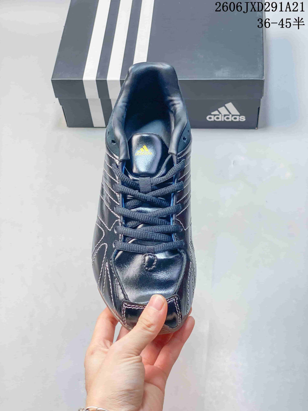 Top view of the lace-up dark navy sneaker with padded tongue and Adidas branding.