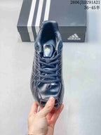 Top view of the lace-up dark navy sneaker with padded tongue and Adidas branding.