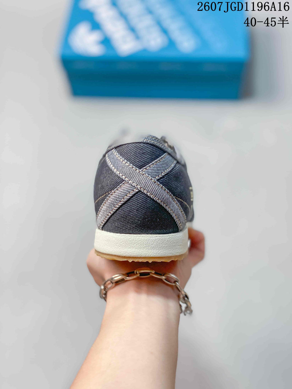 Rear view showing the dark denim-look heel and contrasting crossed overlay details.