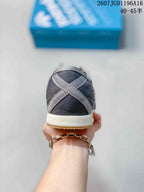 Rear view showing the dark denim-look heel and contrasting crossed overlay details.