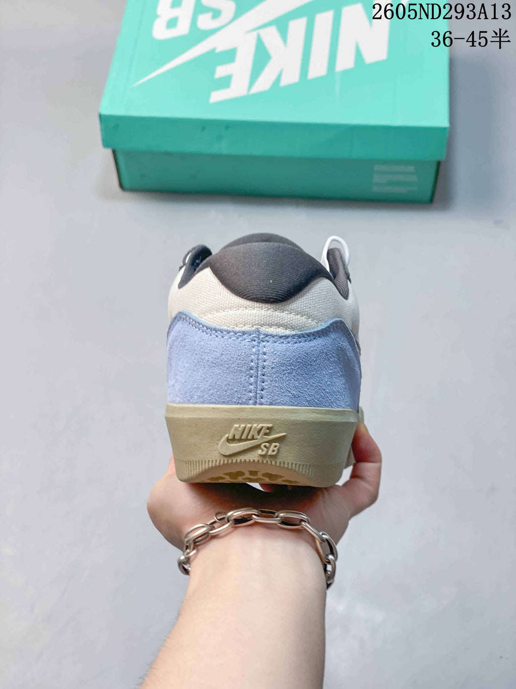 Rear view of the sneaker showing the light blue heel panel, padded collar and Nike SB branding on the heel.