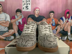 Front view of gray snakeskin-style patterned sneakers with light laces and gum-colored outsoles.