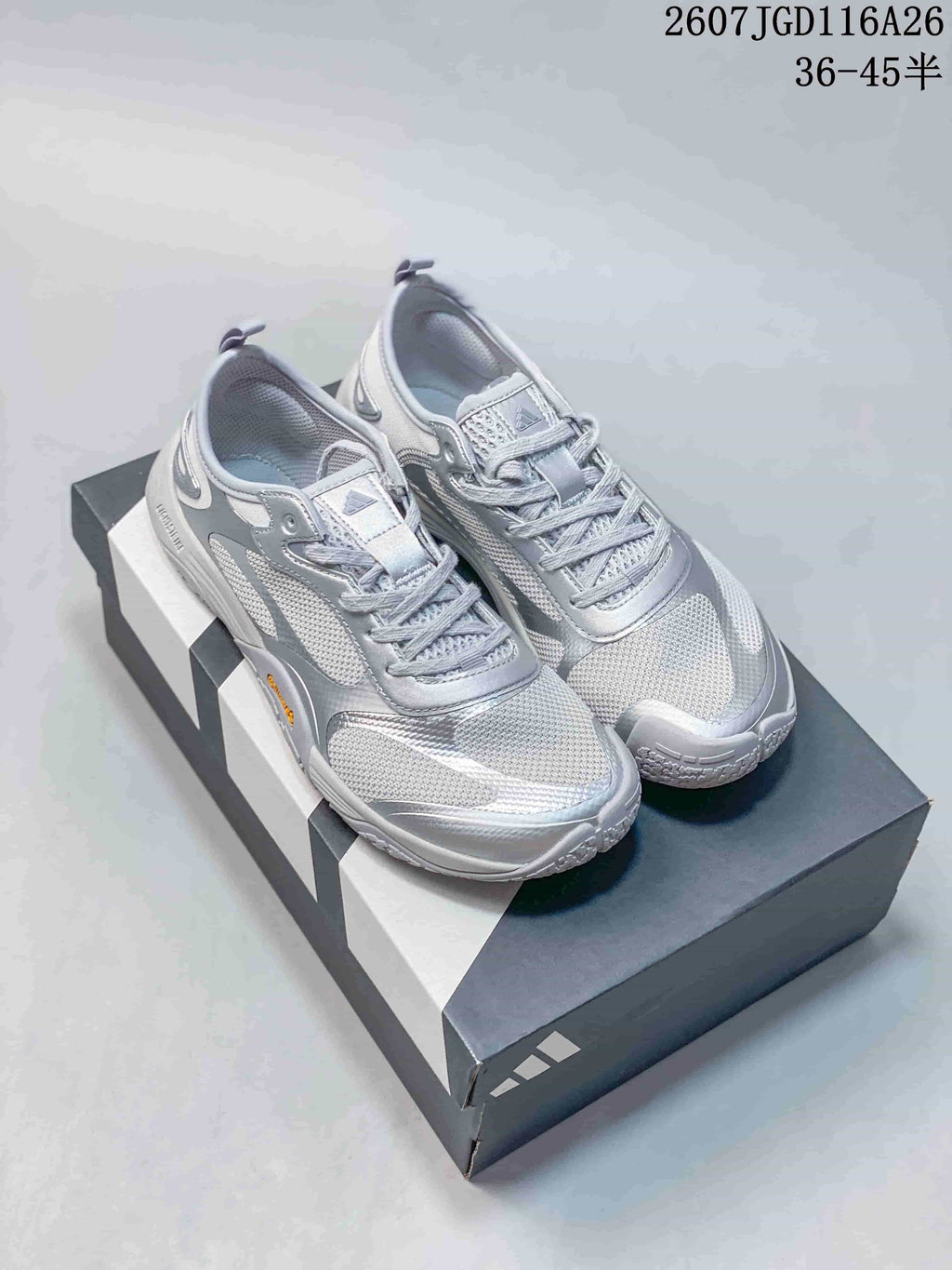 Pair of silver gray adidas Groundflow sneakers displayed on a shoebox
