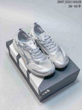 Pair of silver gray adidas Groundflow sneakers displayed on a shoebox