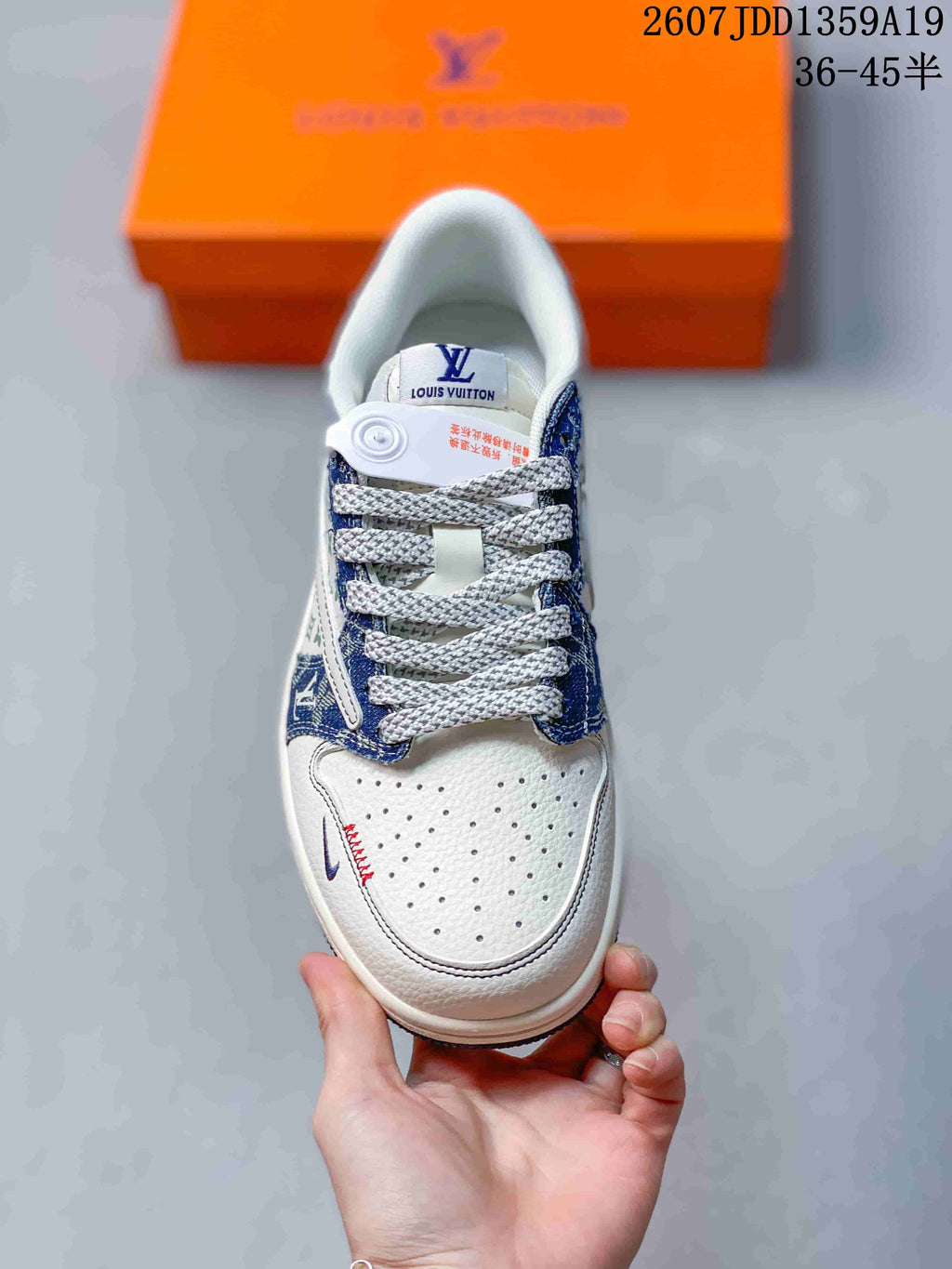 Top view showing the perforated white toe box, woven laces, blue overlays, and tongue branding.