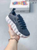 Black and white Nike Mind 002 kids sneaker with a perforated upper and contrast sole.