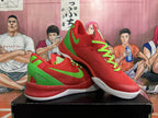 Angled view of red Nike Kobe basketball shoes with green accents