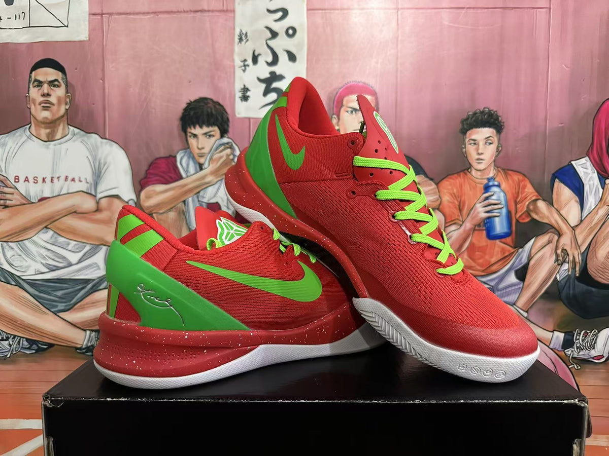 Angled view of red Nike Kobe basketball shoes with green accents