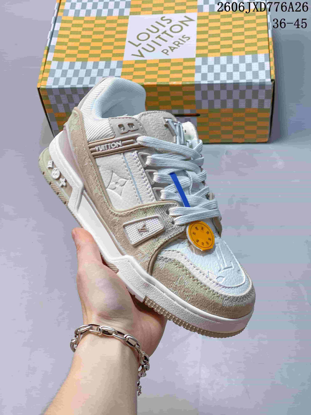 Angled view of a white and beige Louis Vuitton Trainer sneaker