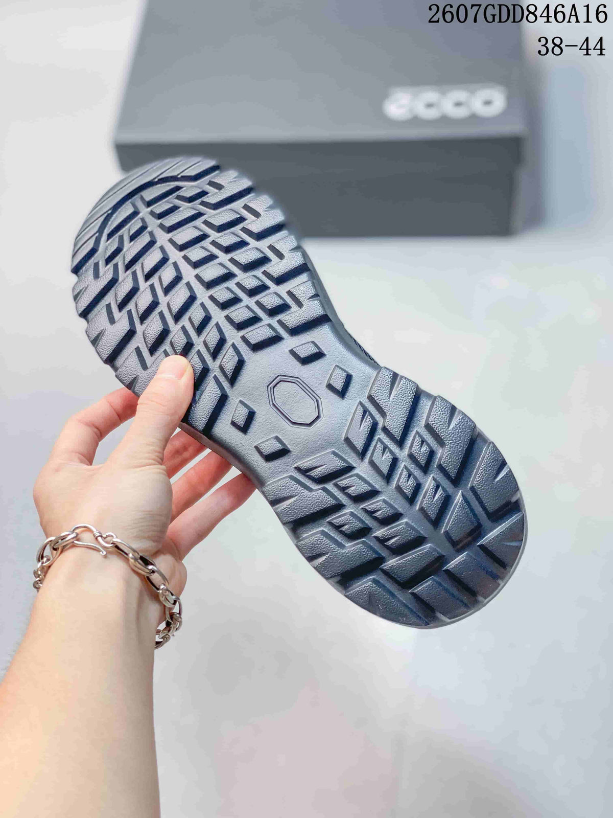 Close view of the sneaker outsole showing a deep geometric lugged tread pattern.