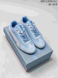 Pair of light blue PUMA Speedcat sneakers displayed on a patterned shoebox; size range and style code are visible at the top.
