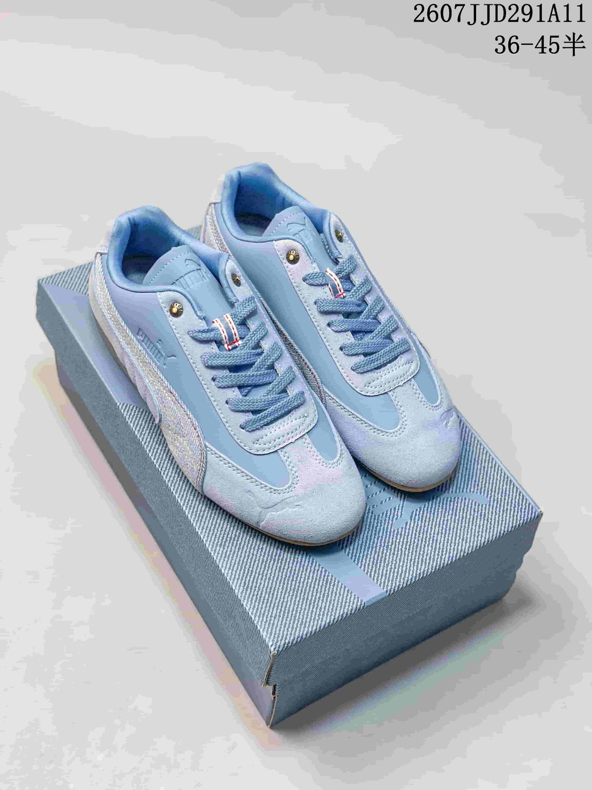 Pair of light blue PUMA Speedcat sneakers displayed on a patterned shoebox; size range and style code are visible at the top.