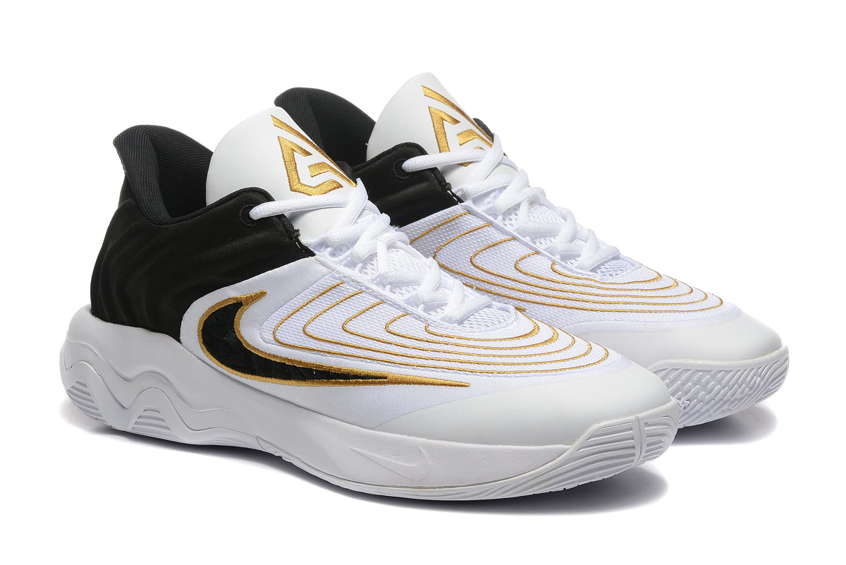Pair of white Nike Zoom Freak 5 basketball shoes with black and gold detailing