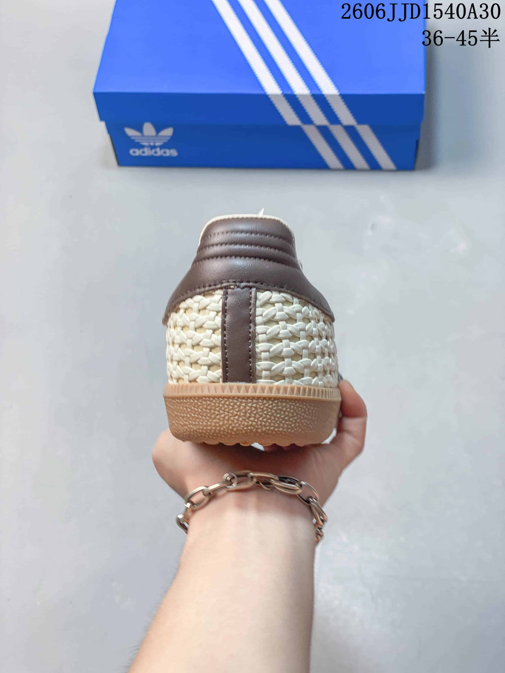 Rear view showing the woven-look heel panels and taupe-brown heel detail