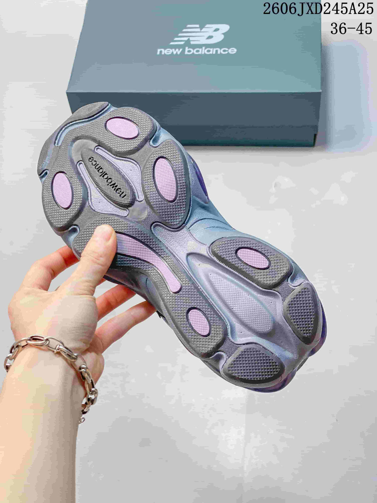 Underside of a blue and gray sneaker showing purple outsole details