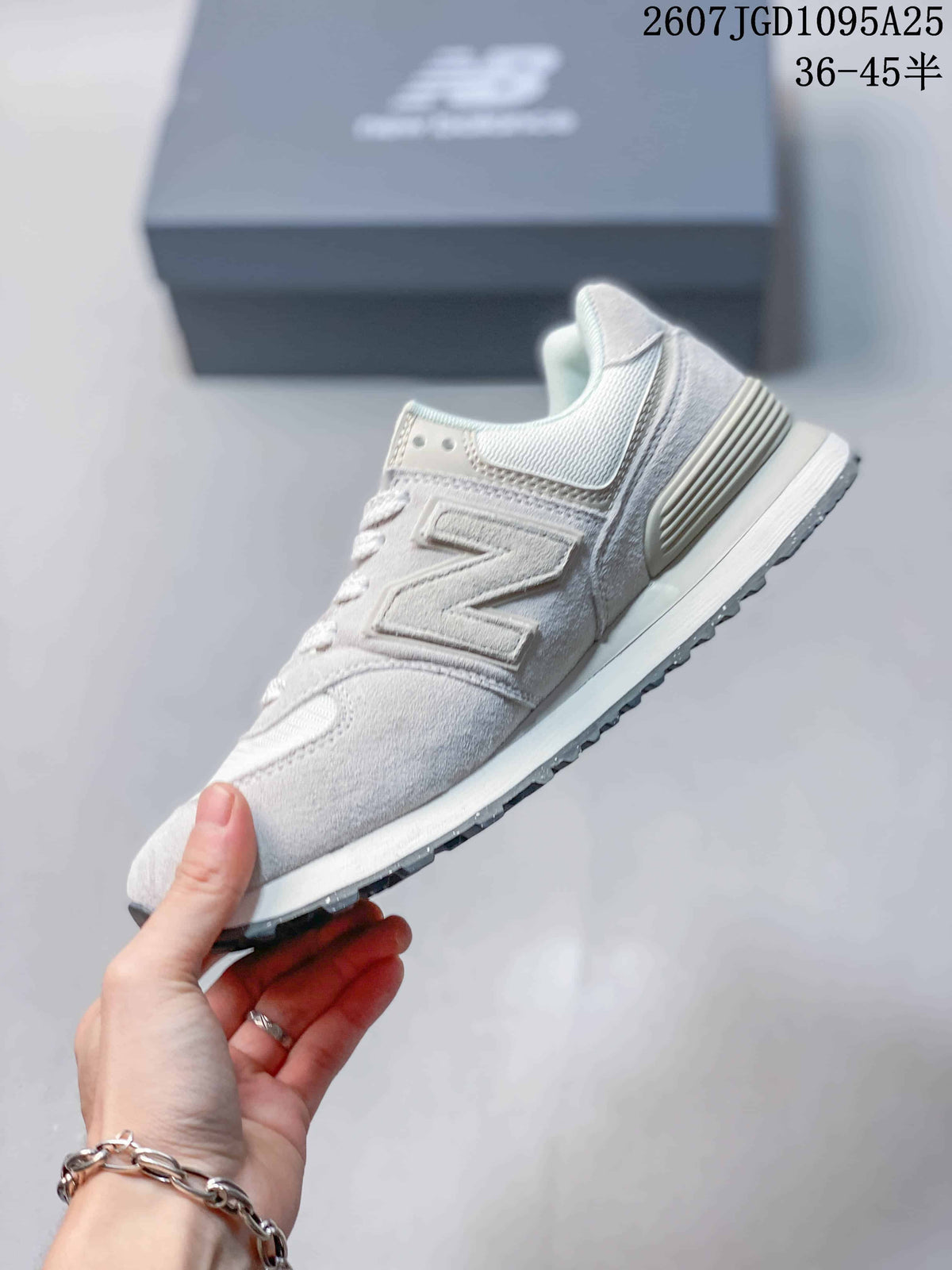 Side profile of a white and grey New Balance 574 sneaker with the signature side logo and textured outsole.
