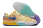 Pale yellow Nike Ja 1 basketball shoes with teal, purple, and orange accents.