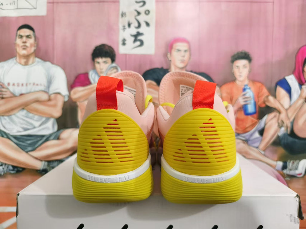 Rear view of pink and yellow basketball sneakers with red heel pull tabs