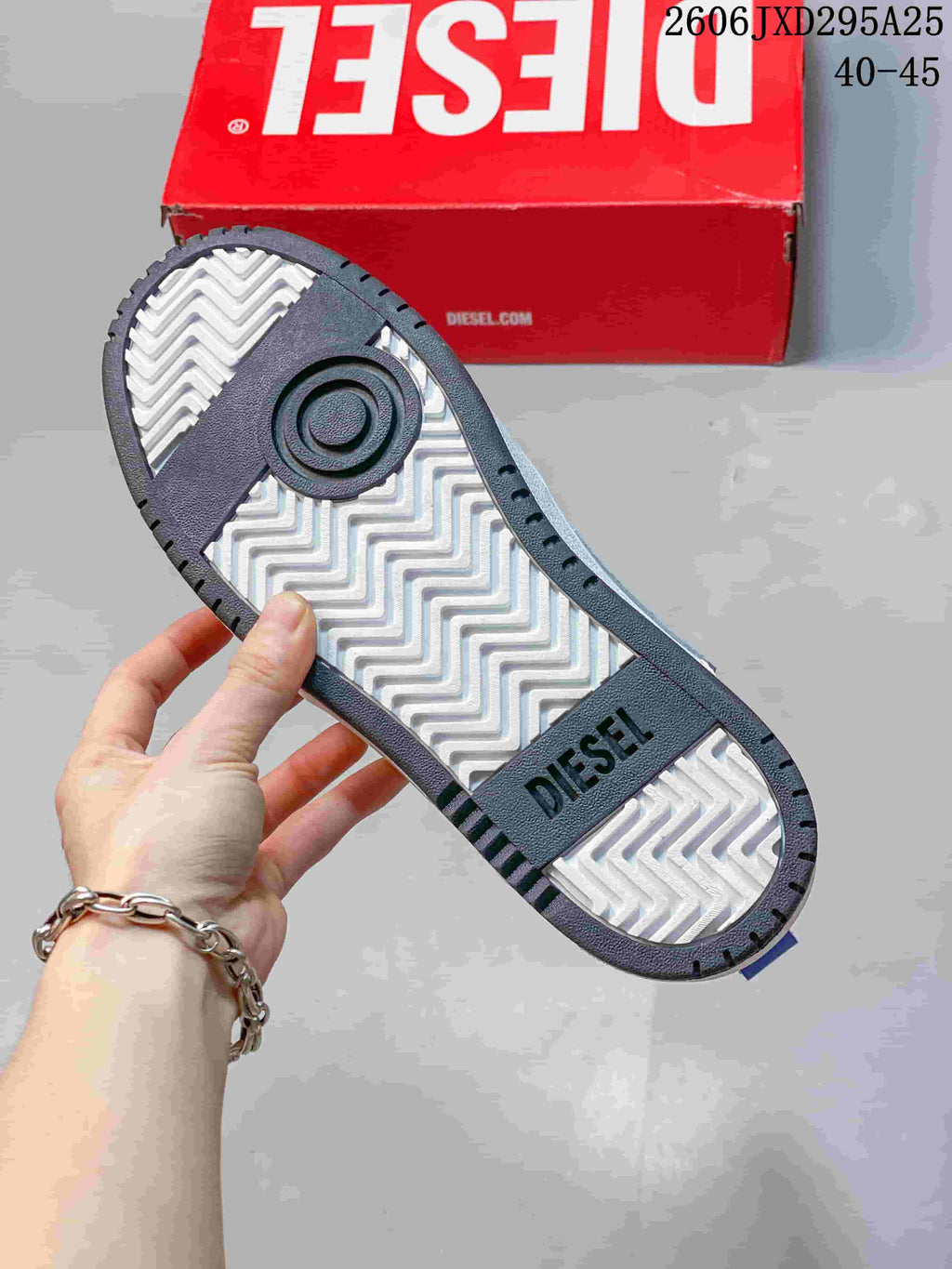 Underside of a sneaker showing a patterned tread and Diesel lettering