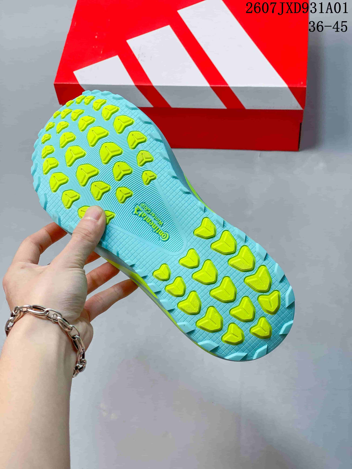 Close-up of the aqua outsole with bright lime tread on the adidas Hyperboost ATR.