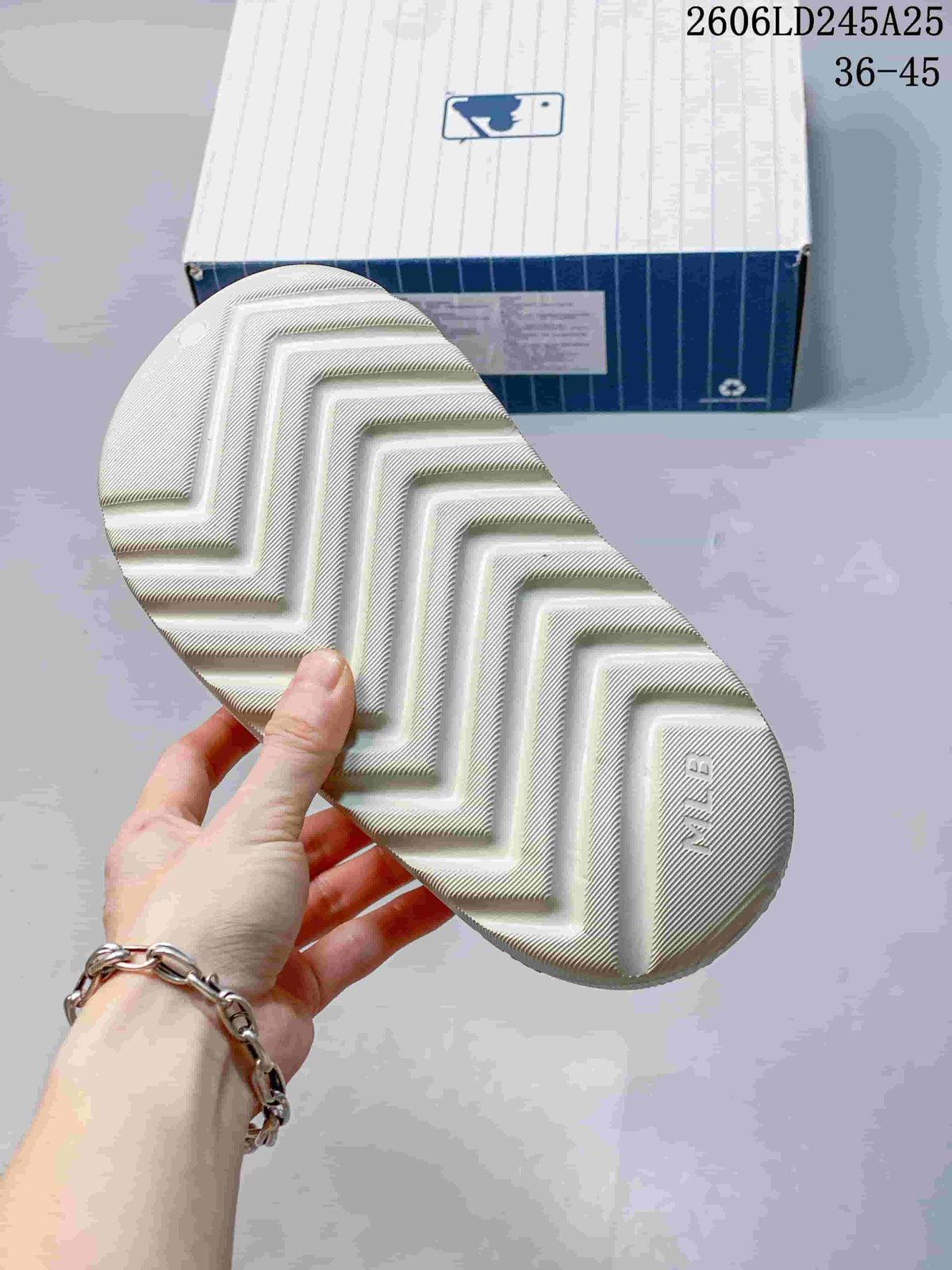 Close view of the geometric tread pattern on the outsole of an off-white slide sandal.