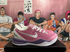 Side view showing pink upper, white side logo and heel panel, and purple-speckled midsole.