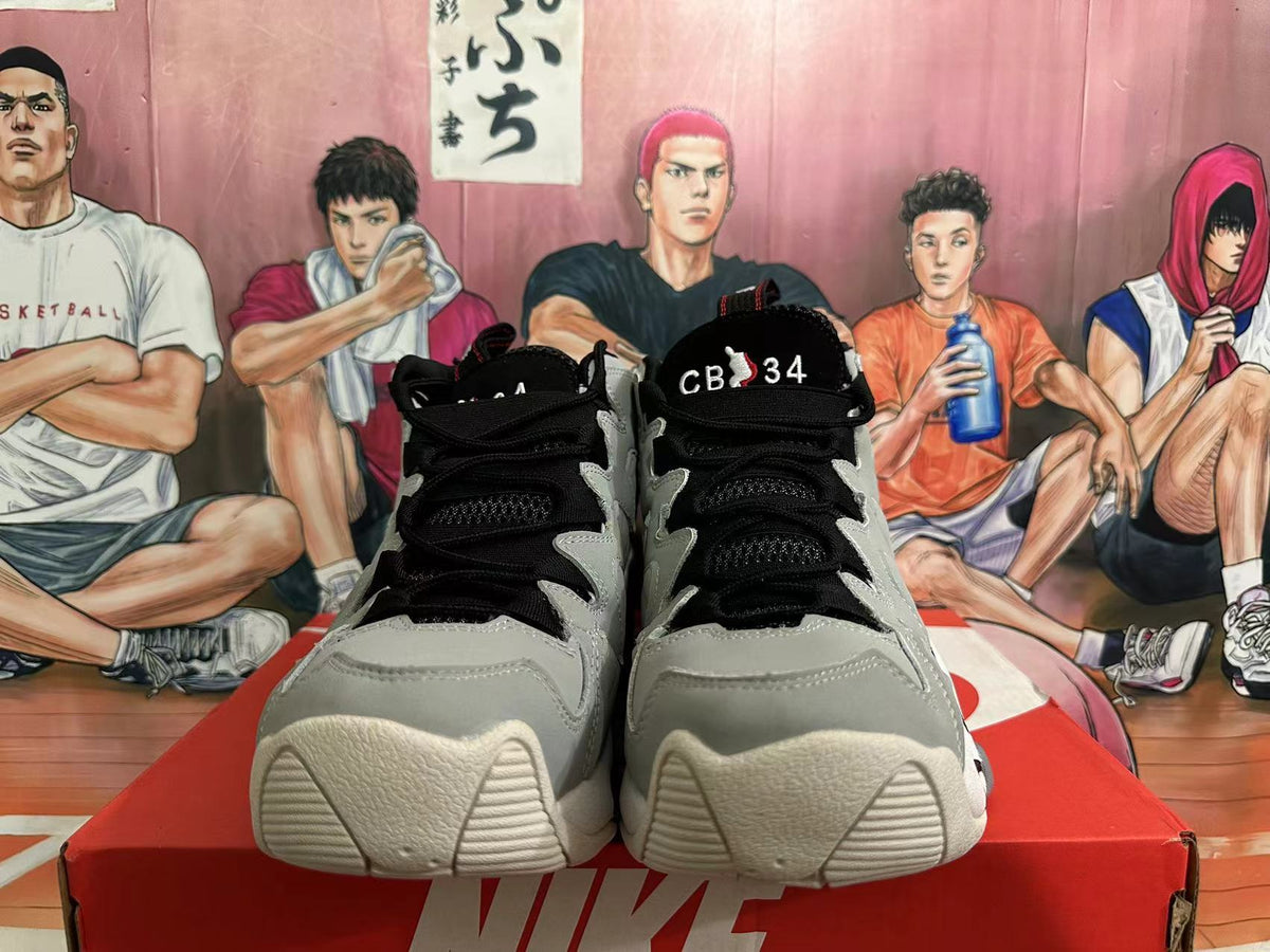 Front view of the shoes showing black laces, grey toe panels, and CB 34 tongue lettering