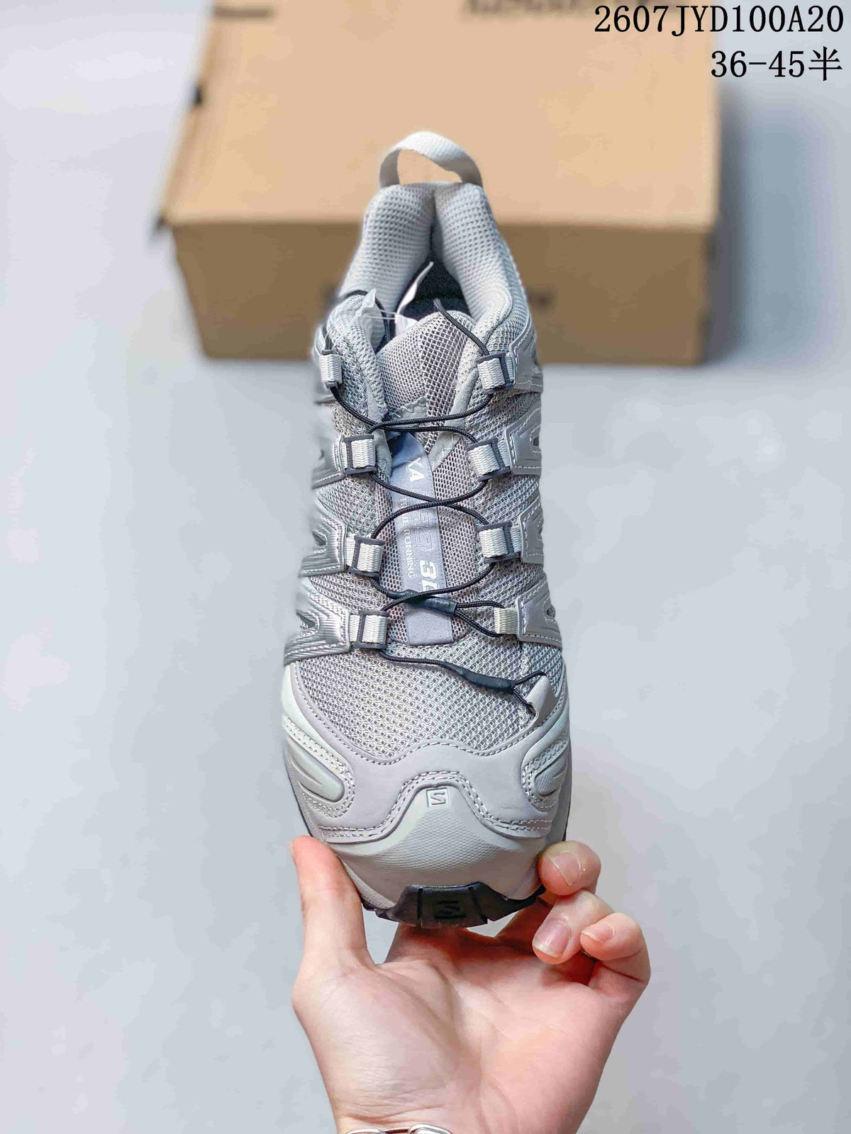 Top view of the grey shoe showing the mesh-look upper, tongue and adjustable lace system.