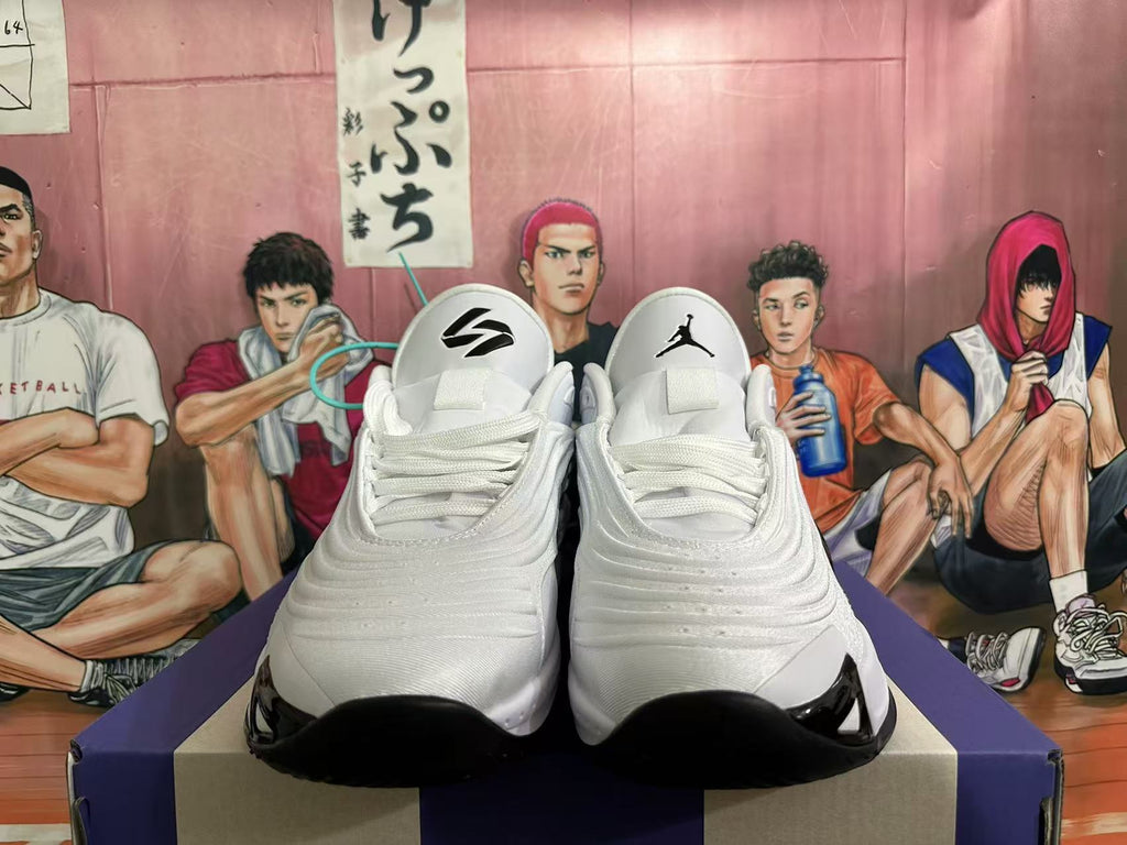 Front view of white Jordan sneakers with lace-up closures and black outsole accents