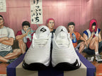 Front view of white Jordan sneakers with lace-up closures and black outsole accents