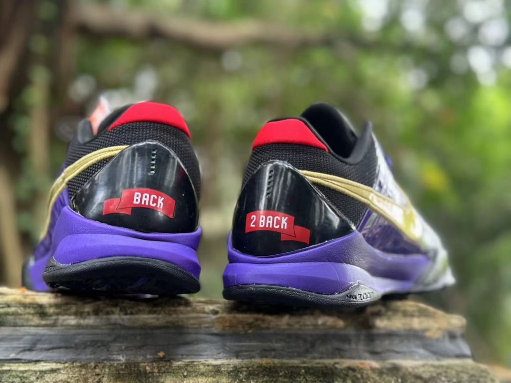Rear view of the pair showing purple midsoles, black heel panels and red accents.