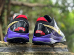 Rear view of the pair showing purple midsoles, black heel panels and red accents.