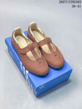 Pair of brown adidas Samba Jane-style Mary Jane sneakers displayed on a blue adidas shoebox, with the style code and size range visible above.