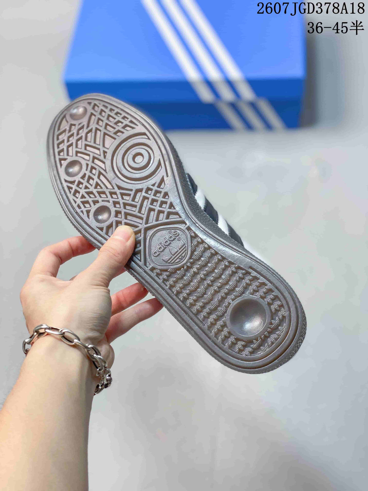 Close view of the sneaker outsole showing a patterned tread and Adidas branding.