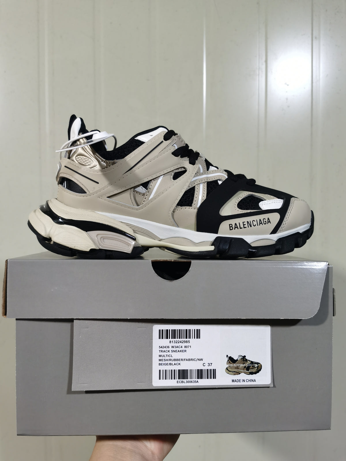Side profile of the Balenciaga Track sneaker resting on its box; the label shows style code 542436 W3AC4 8071 and color Beige/Black.