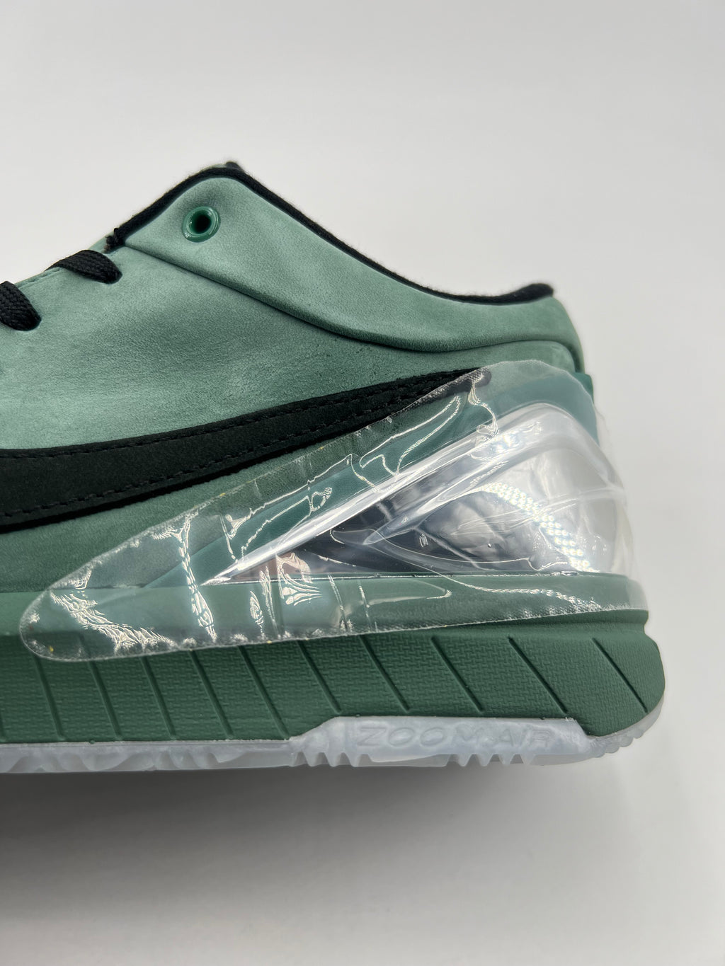Close-up of the green heel, clear accent and midsole