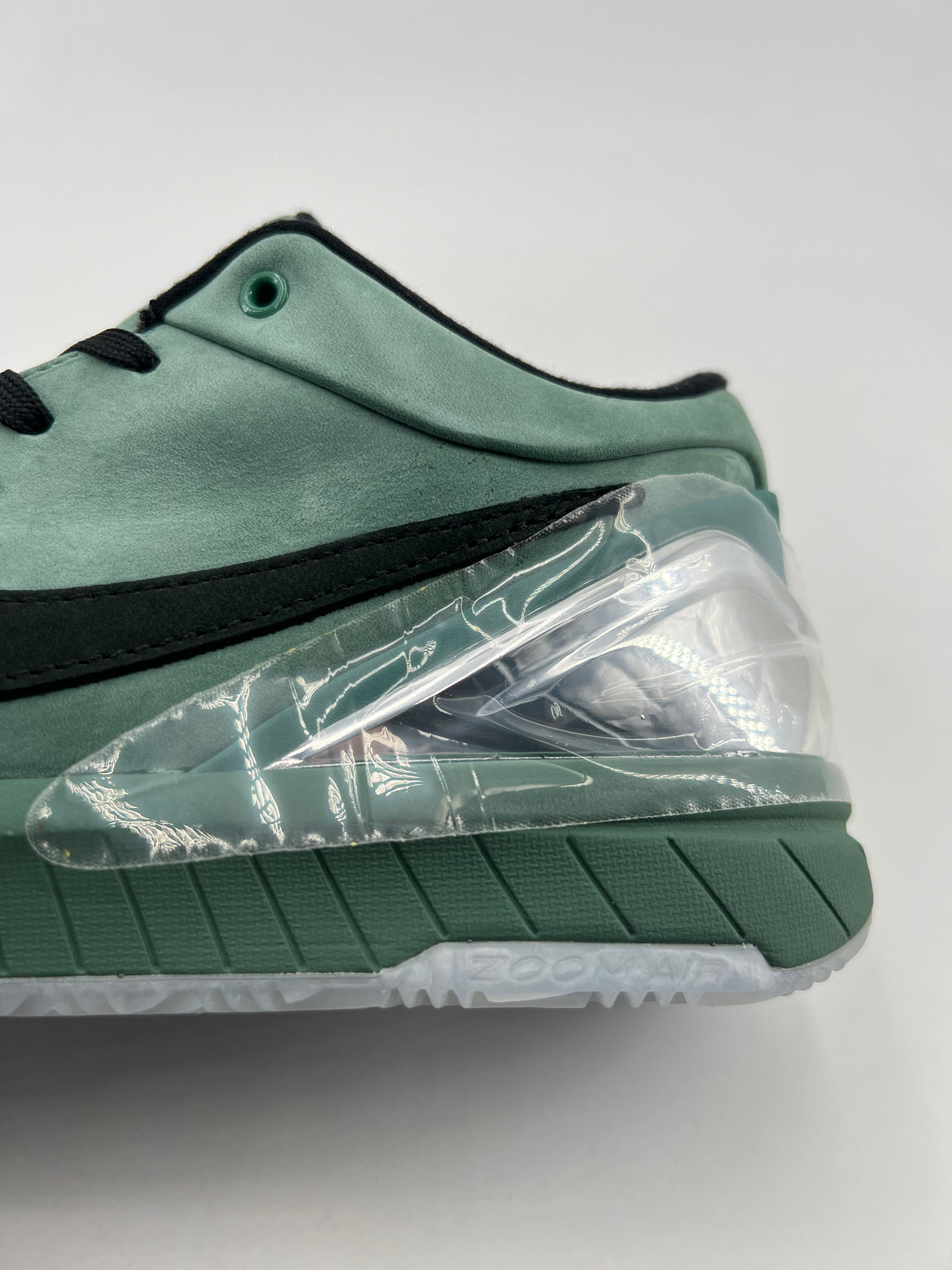 Close-up of the green heel, clear accent and midsole