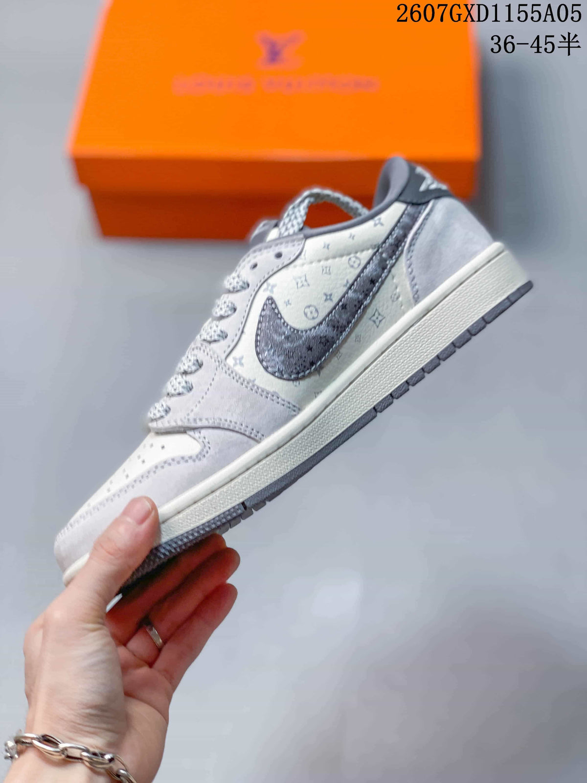 Side profile showing the white and gray low-top sneaker, dark gray side overlay, monogram print, and white midsole.