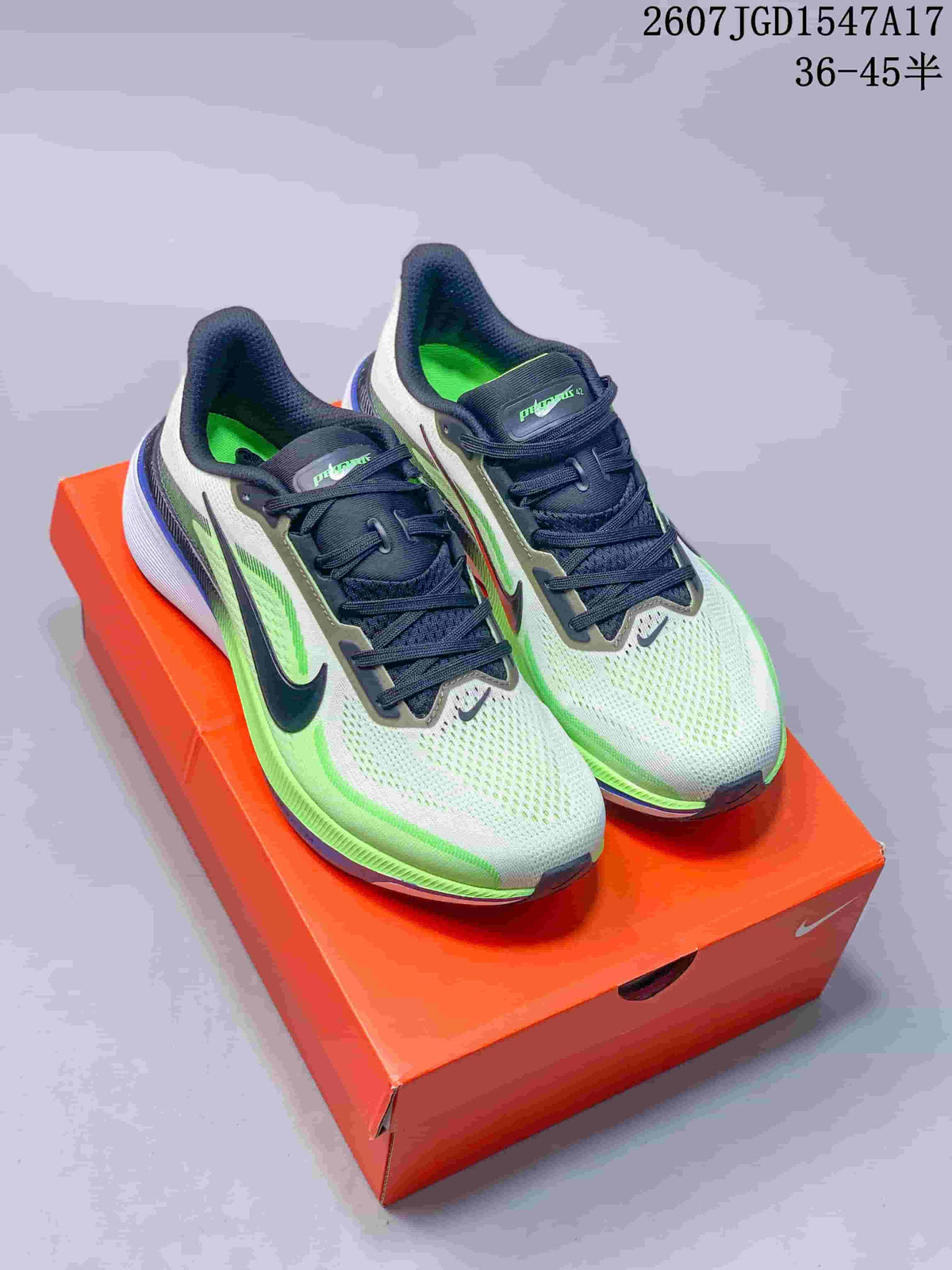 Pair of pale green and white Nike Pegasus 42 sneakers displayed on an orange shoebox, with black details and blue accents.