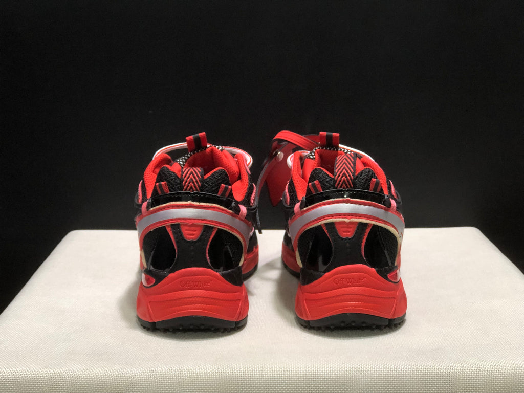 Rear view of the sneakers showing padded collars, heel details, and red outsoles.