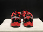 Rear view of the sneakers showing padded collars, heel details, and red outsoles.