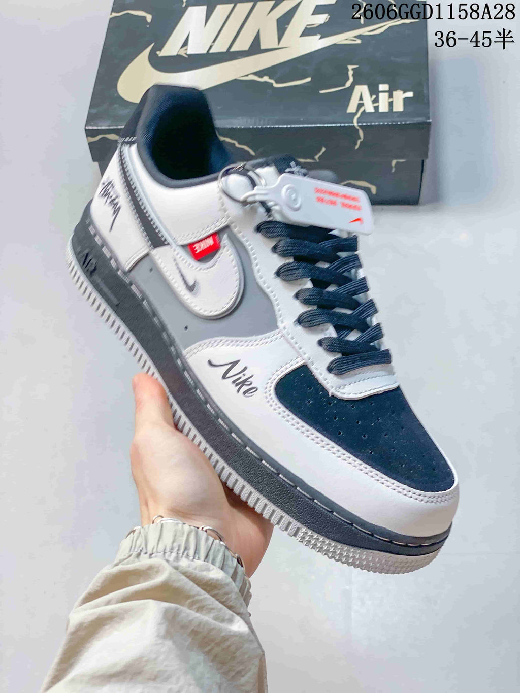 Angled view highlighting navy accents, layered side details, contrast stitching, and a dark midsole.