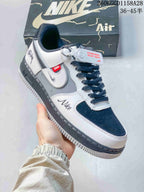 Angled view highlighting navy accents, layered side details, contrast stitching, and a dark midsole.