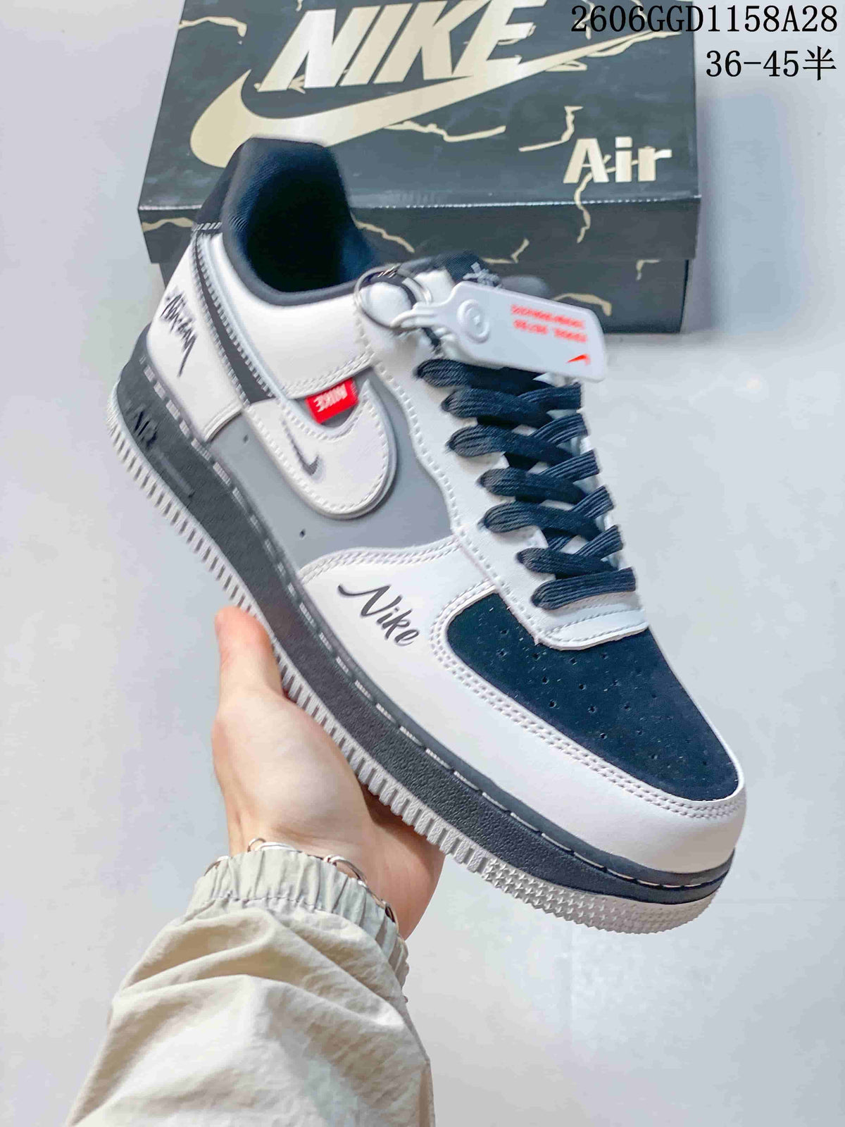 Angled view highlighting navy accents, layered side details, contrast stitching, and a dark midsole.