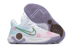 White and pale blue basketball shoe with pink blossom graphics, green Swoosh, and lavender outsole.