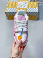 Top view of a pink and white sneaker with white laces